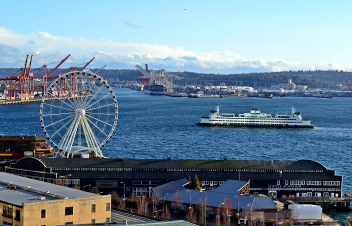 View of Seattle waterfront from the Market: Aquarium building in foreground, Seattle Great Wheel, and Washington State ferry